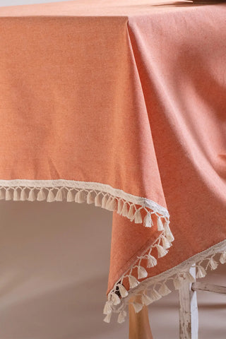 Orange handwoven solid color Turkish cotton tassel tablecloth folded flat lay. Tasseled edges Denizli, OEKO-TEX. Vivamaison.