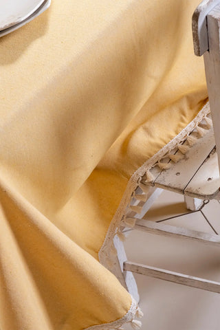 Yellow handwoven solid color Turkish cotton tassel tablecloth folded flat lay. Tasseled edges Denizli, OEKO-TEX. Vivamaison.