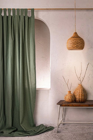 Dark green stonewashed cotton curtain panel with a rattan pendant lamp. Handwoven in Denizli, OEKO-TEX. Vivamaison.