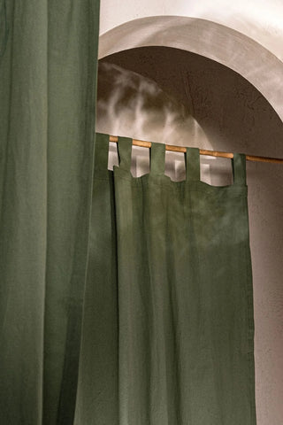 Dark green stonewashed cotton curtain tab top loops on a bamboo rod. Handwoven in Denizli, OEKO-TEX. Vivamaison.