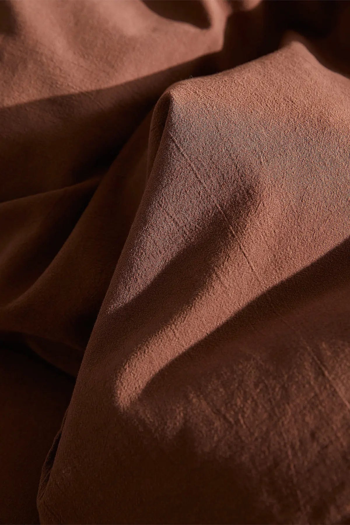 Brown stonewashed Turkish cotton duvet cover, styled on a bed. Made in Denizli, Turkey. VivaMaison
