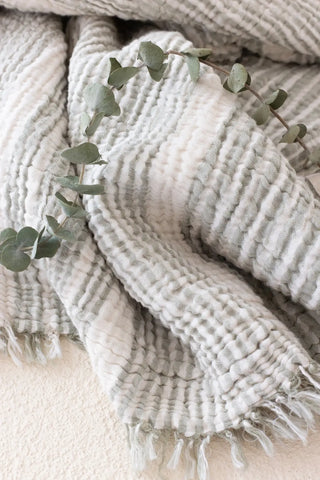 Green striped peshtemal towel fringe detail closeup. Handwoven Turkish cotton Denizli, OEKO-TEX. Vivamaison.