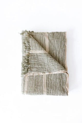 Green striped peshtemal towel folded flat lay. Handwoven Turkish cotton Denizli, OEKO-TEX. Vivamaison.