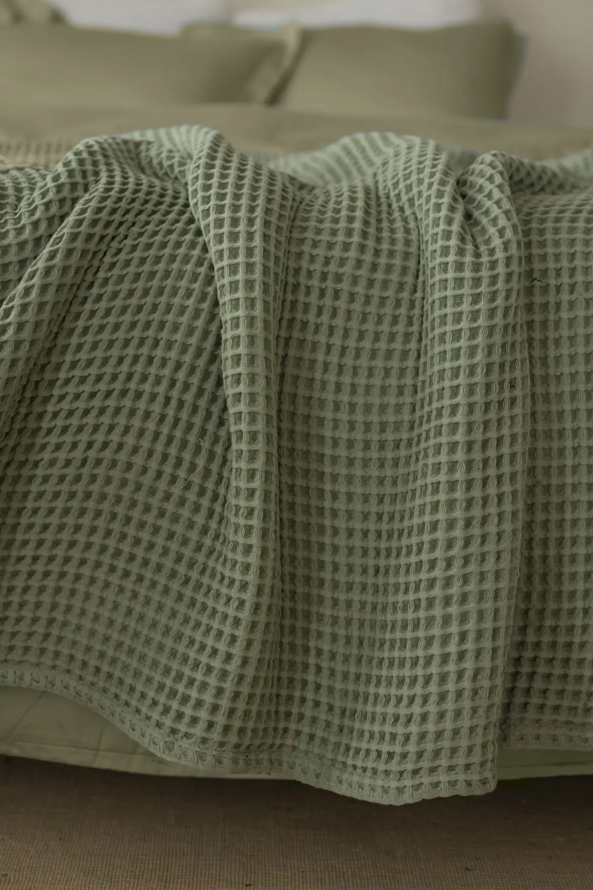 Sage Green handwoven Turkish cotton waffle weave bedspread folded flat lay. 350 GSM Denizli, OEKO-TEX. Vivamaison.