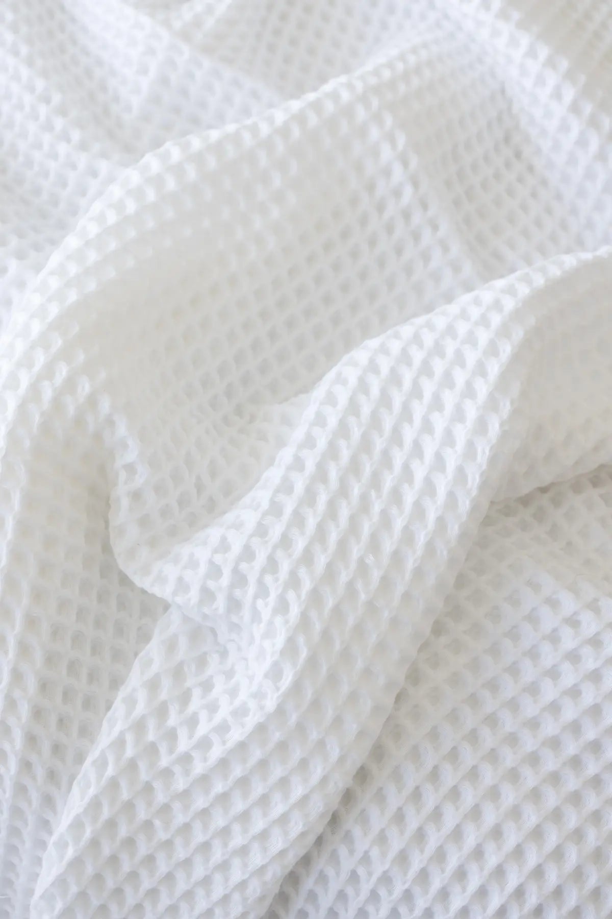 White handwoven Turkish cotton waffle weave bedspread folded flat lay. 350 GSM Denizli, OEKO-TEX. Vivamaison.