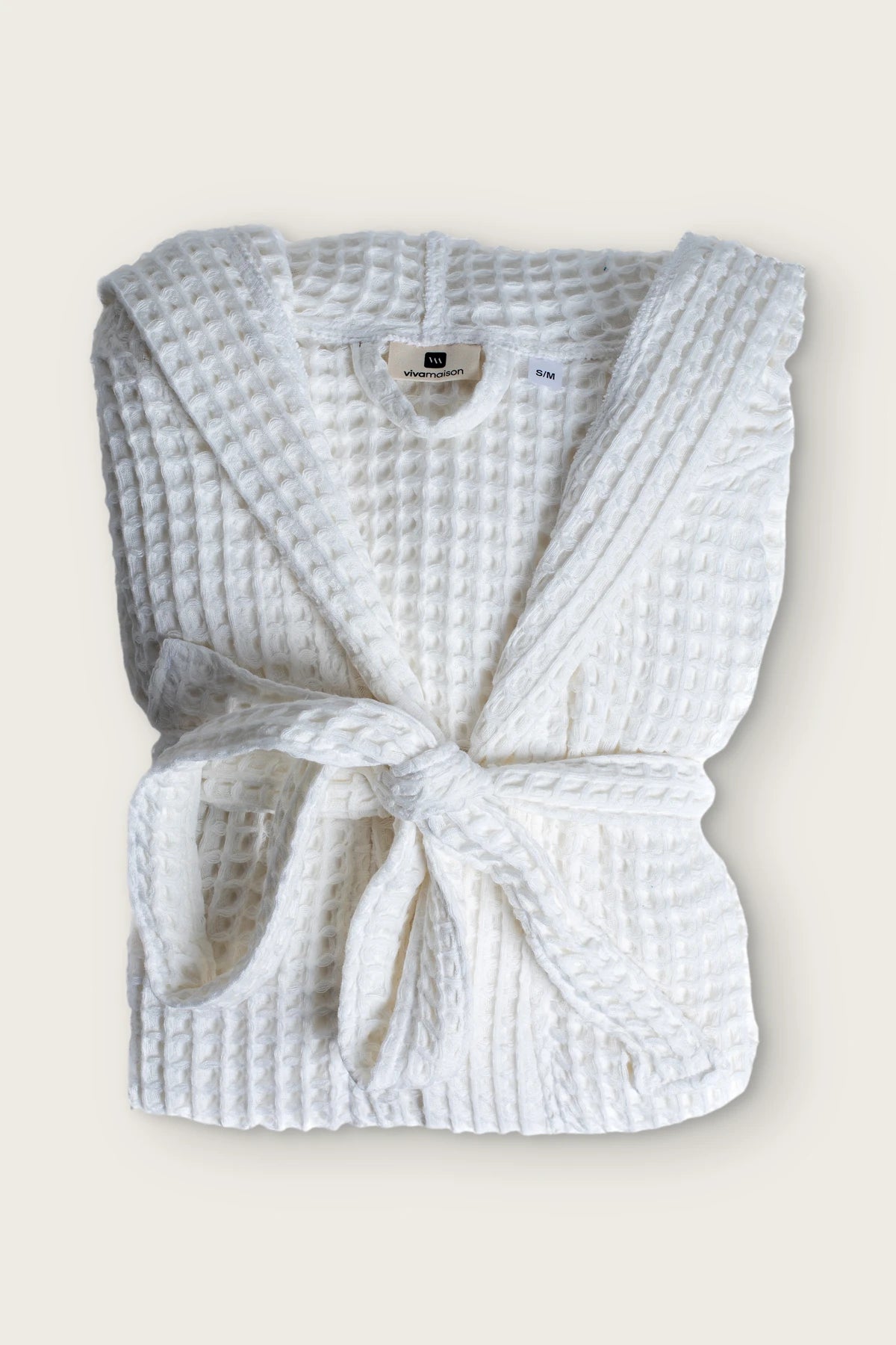 Handwoven waffle hooded bathrobe in white, folded front view with tied belt