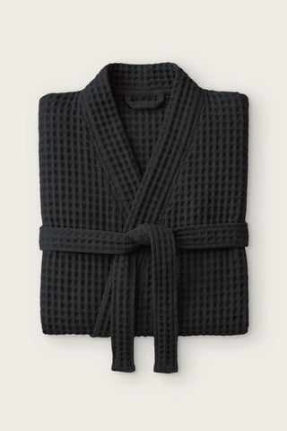 Handwoven waffle kimono bathrobe in black, folded front view with tied belt