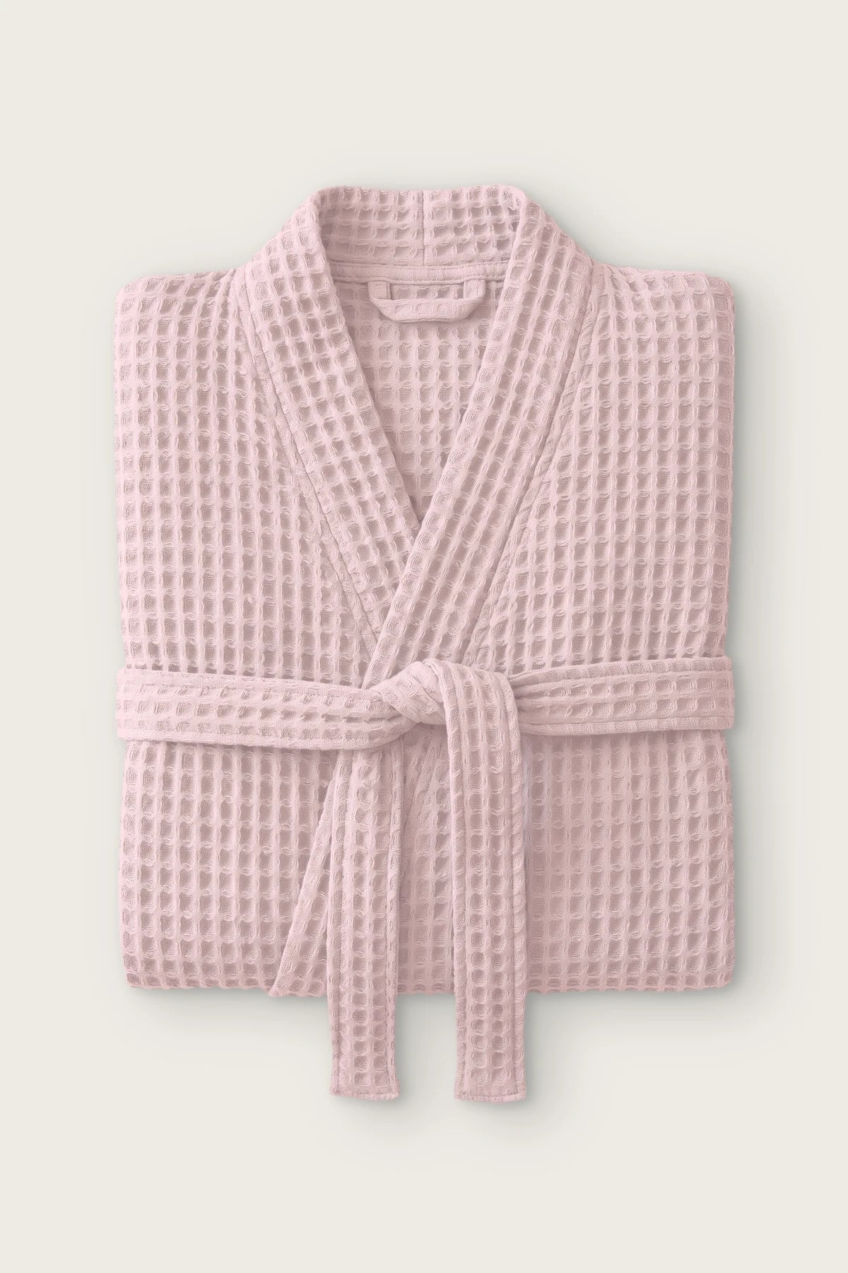 Handwoven waffle kimono bathrobe in pink, folded front view with tied belt