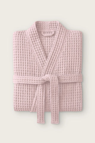 Handwoven waffle kimono bathrobe in pink, folded front view with tied belt