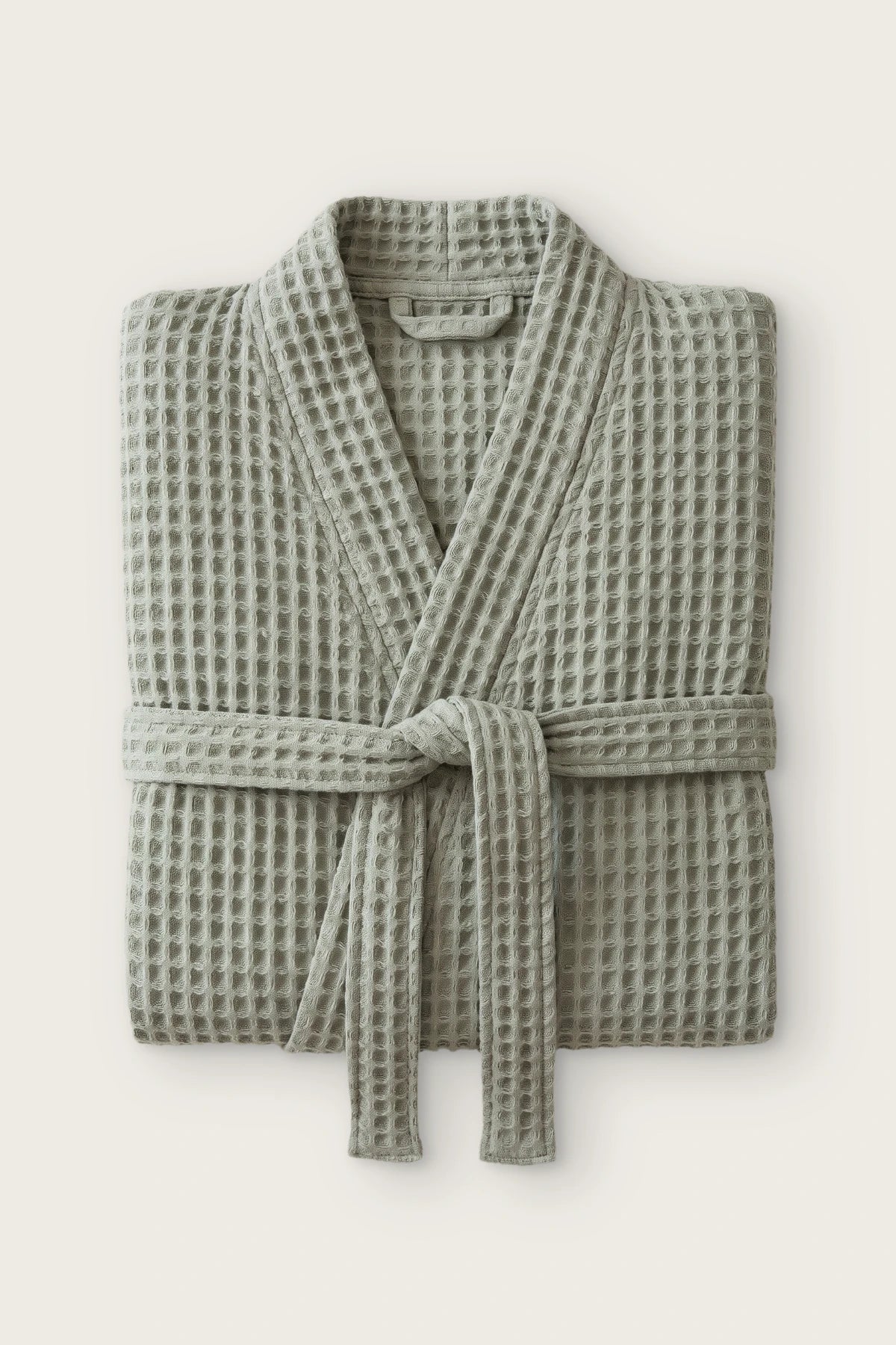 Handwoven waffle kimono bathrobe in sage green, folded front view with tied belt