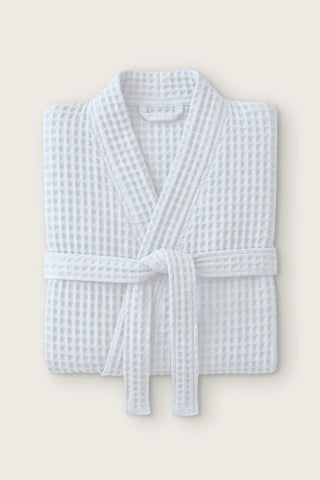 Handwoven waffle kimono bathrobe in white, folded front view with tied belt