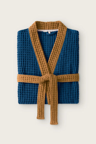 Handwoven two-tone waffle kimono bathrobe in indigo blue - caramel, folded front view with contrast collar and tied belt