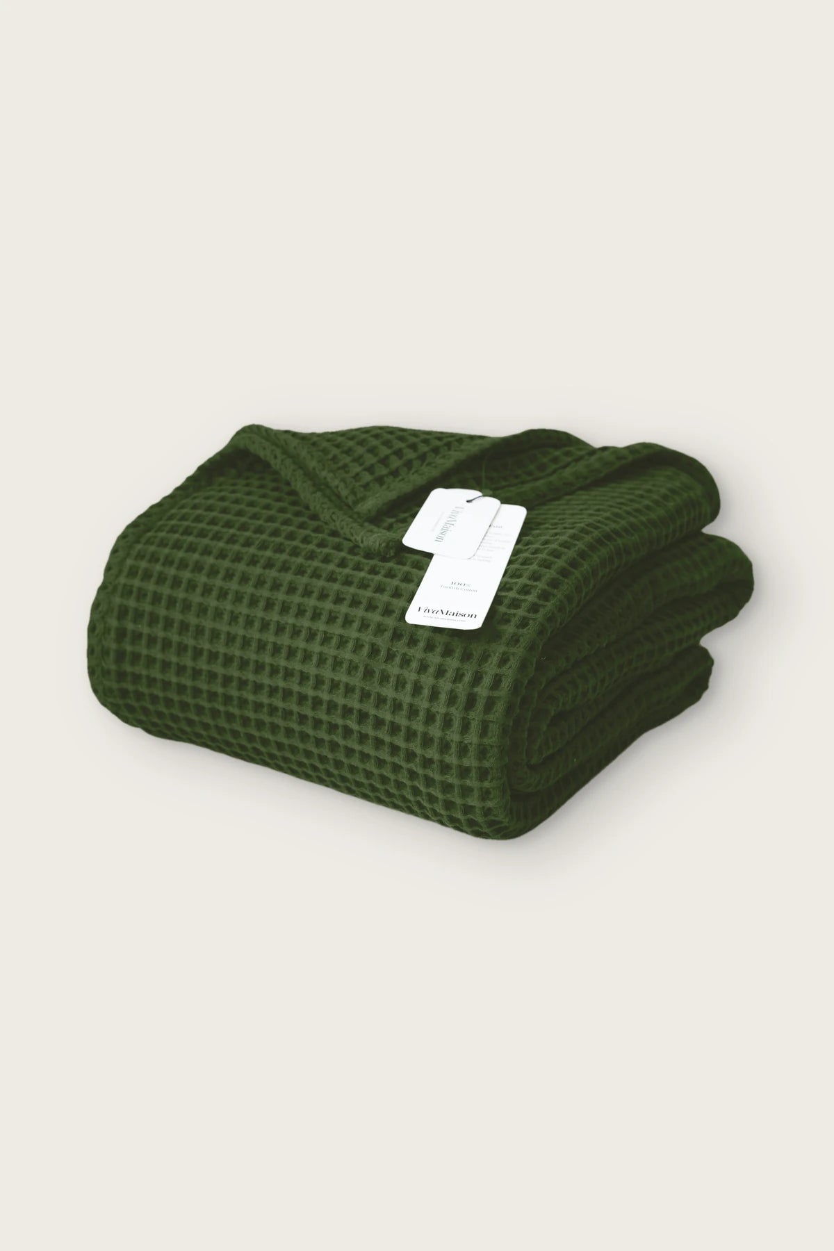 Handwoven Turkish cotton waffle weave bedspread in dark green, folded front view