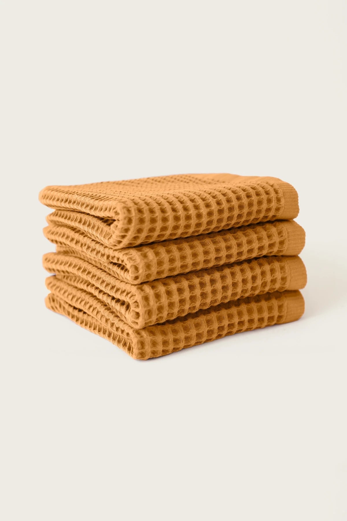 Caramel handwoven Turkish cotton waffle weave towel set of 4 hand towels stacked. Denizli, OEKO-TEX. Vivamaison.