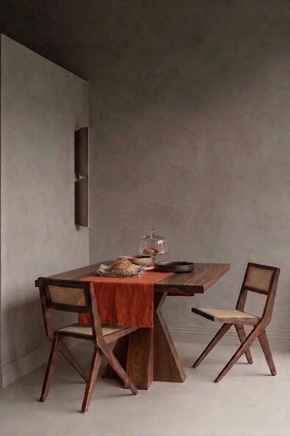 Cinnamon plain linen cotton blend table runner styled in a modern dining room with cane chairs. 16 x 51 in, handmade in Denizli, OEKO-TEX. VivaMaison.