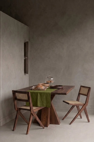 Olive Green plain linen cotton blend table runner styled in a modern dining room with cane chairs. 16 x 51 in, handmade in Denizli, OEKO-TEX. VivaMaison.