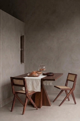 White plain linen cotton blend table runner styled in a modern dining room with cane chairs. 16 x 51 in, handmade in Denizli, OEKO-TEX. VivaMaison.
