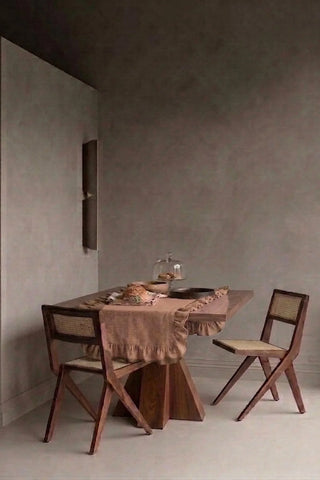 Brown ruffled linen cotton blend table runner styled in a modern dining room with cane chairs. 16 x 51 in, handmade in Denizli, OEKO-TEX. VivaMaison.