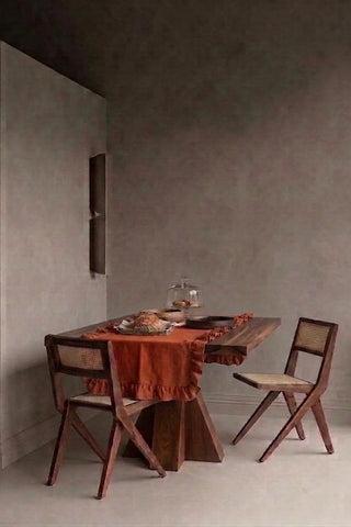 Cinnamon ruffled linen cotton blend table runner styled in a modern dining room with cane chairs. 16 x 51 in, handmade in Denizli, OEKO-TEX. VivaMaison.