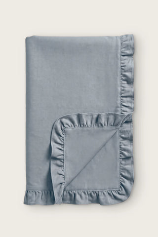 Ruffled linen cotton blend table runner in gray, folded in half with corner turned back
