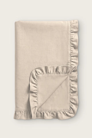 Ruffled linen cotton blend table runner in natural, folded in half with corner turned back