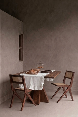 White ruffled linen cotton blend table runner styled in a modern dining room with cane chairs. 16 x 51 in, handmade in Denizli, OEKO-TEX. VivaMaison.
