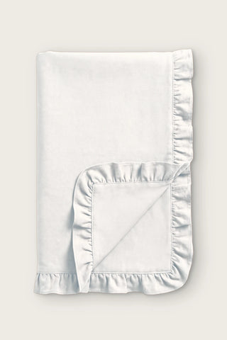Ruffled linen cotton blend table runner in white, folded in half with corner turned back