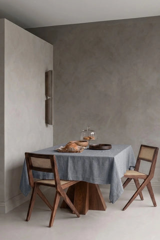 Gray plain linen cotton blend tablecloth on a dining table in a modern dining room with cane chairs. 9 sizes, handmade in Denizli, OEKO-TEX. VivaMaison.