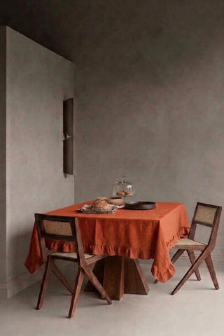 Cinnamon ruffled linen cotton blend tablecloth on a dining table in a modern dining room with cane chairs. 9 sizes, handmade in Denizli, OEKO-TEX. VivaMaison.