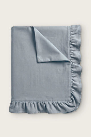 Ruffled linen cotton blend tablecloth in gray, folded with corner turned back