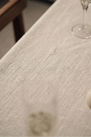 Natural ruffled linen cotton blend tablecloth fabric texture close-up with a wine glass. 9 sizes, handmade in Denizli, OEKO-TEX. VivaMaison.