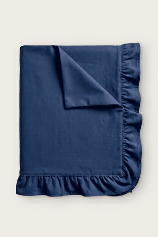 Ruffled linen cotton blend tablecloth in navy, folded with corner turned back