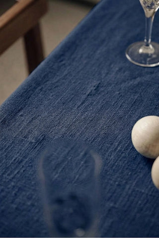 Navy ruffled linen cotton blend tablecloth fabric texture close-up with a wine glass. 9 sizes, handmade in Denizli, OEKO-TEX. VivaMaison.