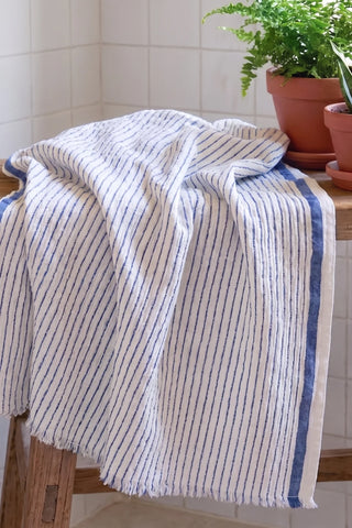 Muslin striped Turkish cotton beach towel peshtemal with blue stripes in a bathroom setting - VivaMaison