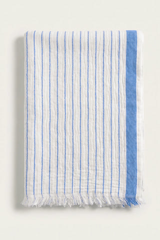 Muslin striped Turkish cotton beach towel peshtemal in blue, folded front view with side band and short fringe