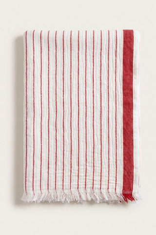 Muslin striped Turkish cotton beach towel peshtemal in red, folded front view with side band and short fringe