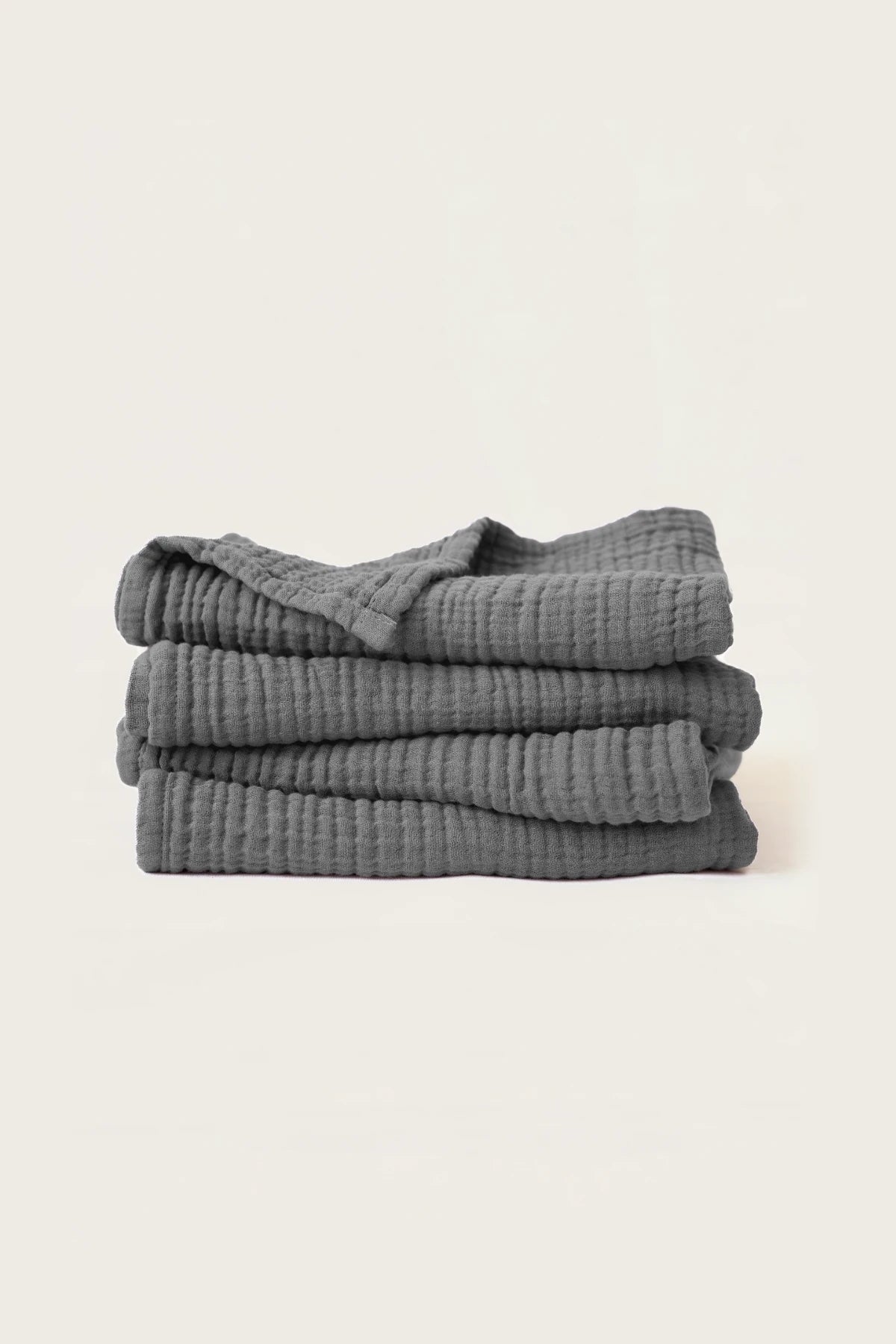 Stacked anthracite muslin Turkish cotton towels with soft 4-layer gauze weave, handwoven in Denizli
