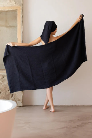 Black handwoven muslin towel in a styled bathroom setting, OEKO-TEX certified VivaMaison Turkish cotton