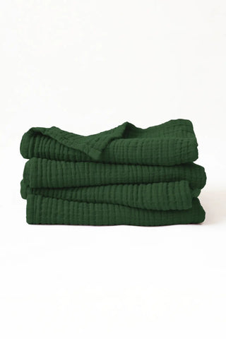 Stacked forest green muslin Turkish cotton towels with soft 4-layer gauze weave, handwoven in Denizli