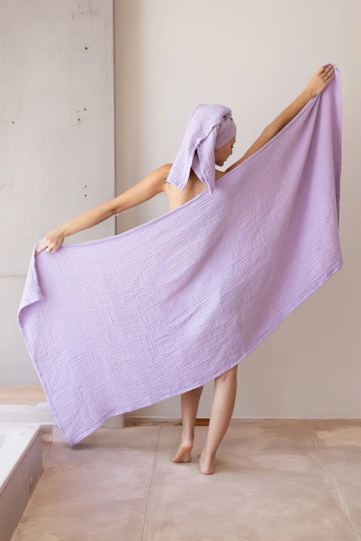 Folded lilac handwoven muslin towels showing the breathable 4-layer cotton texture by VivaMaison