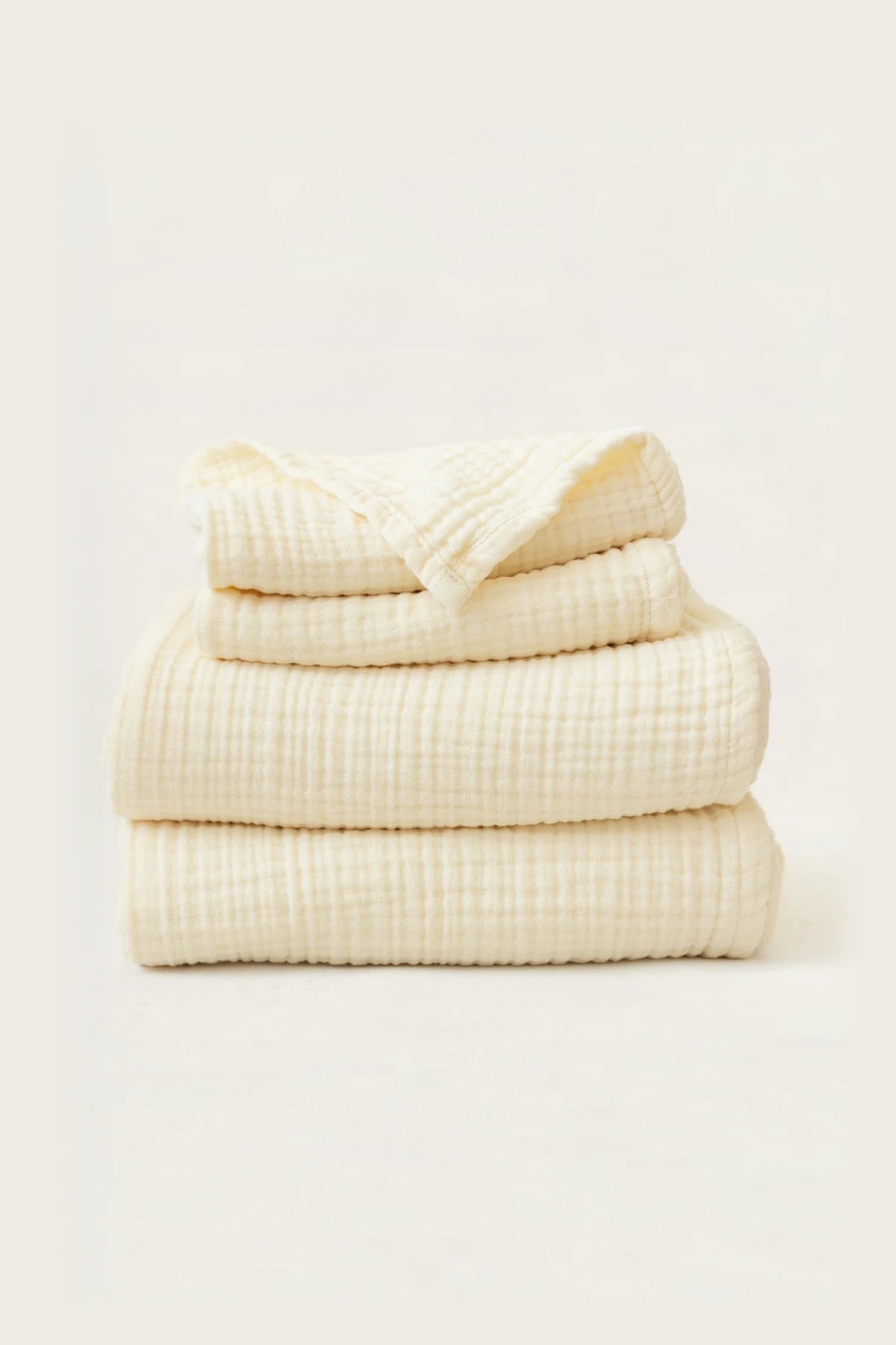Stacked natural muslin Turkish cotton towels showing soft 4-layer gauze weave by VivaMaison Denizli
