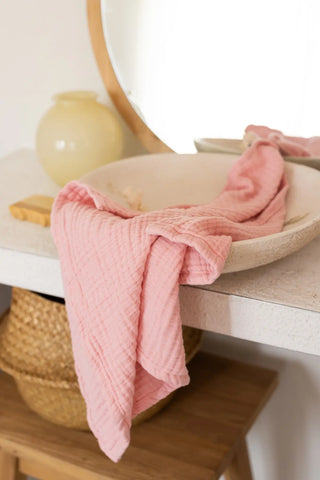 Pink 4-layer muslin bath towel styled in a bathroom — handwoven Turkish cotton, OEKO-TEX certified Denizli