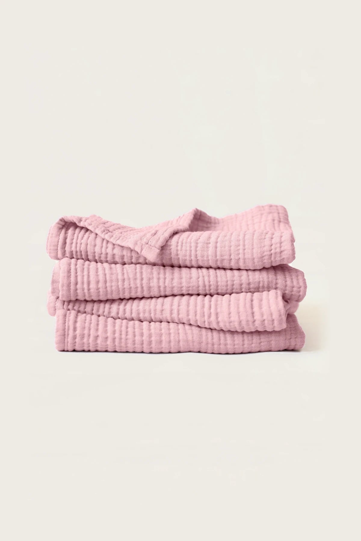 Stacked pink muslin Turkish cotton towels with soft 4-layer gauze weave, handwoven in Denizli
