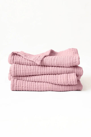 Stacked pink muslin Turkish cotton towels with soft 4-layer gauze weave, handwoven in Denizli