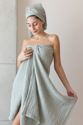Sage green muslin Turkish towel in a serene home scene, handwoven OEKO-TEX certified VivaMaison cotton