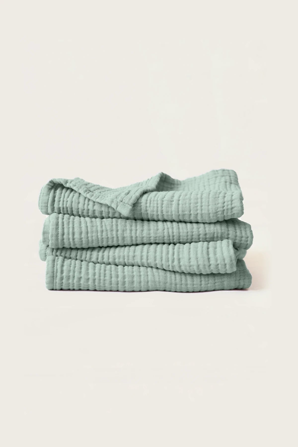 Sage green handwoven muslin towel in a styled bathroom corner, OEKO-TEX certified VivaMaison Turkish cotton