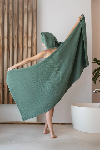 Sage green muslin towel displayed in a natural home setting, handwoven VivaMaison Denizli cotton