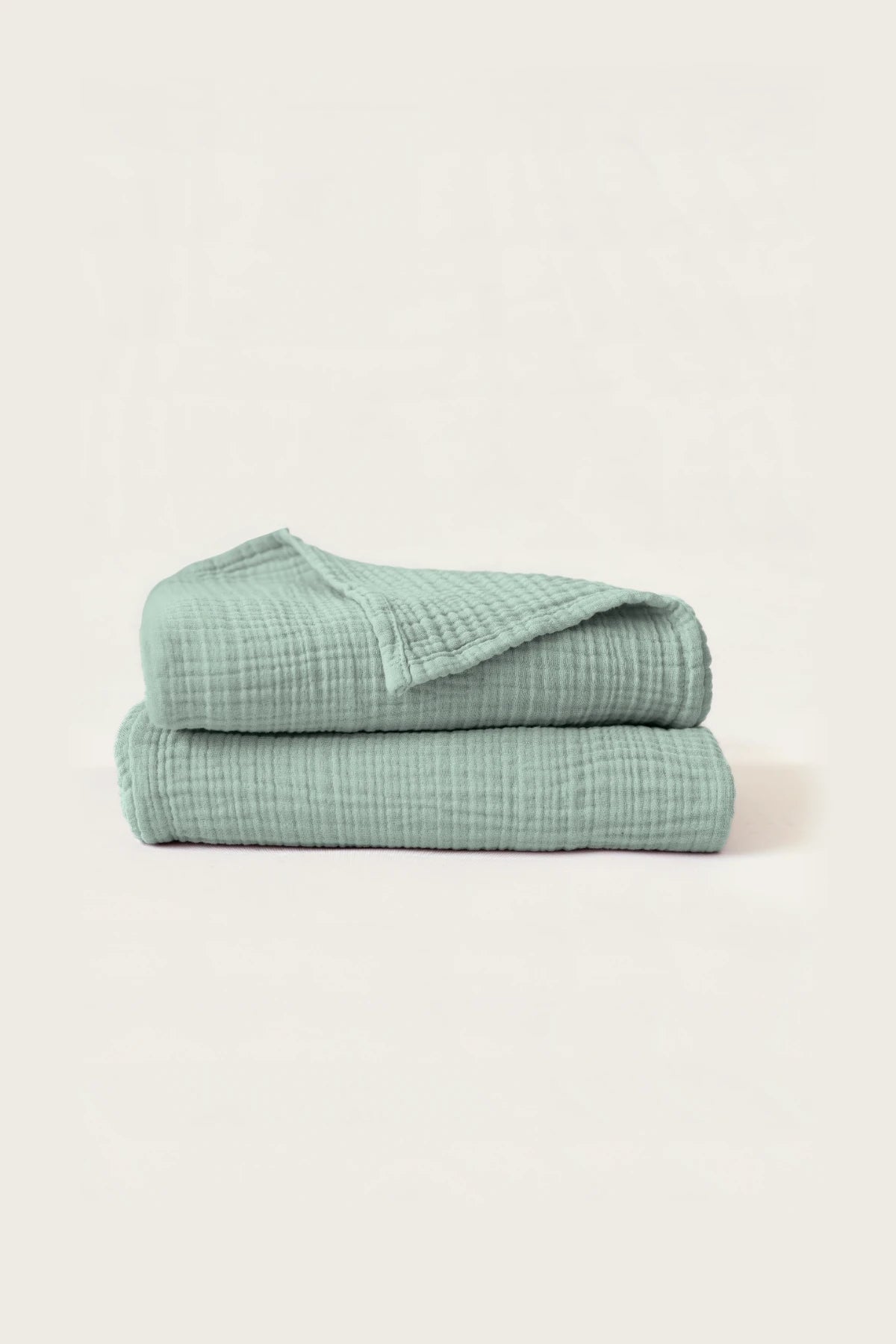 Stacked sage green muslin Turkish cotton towels with soft 4-layer gauze weave, handwoven in Denizli