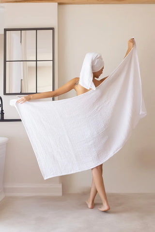 White handwoven muslin towel in a styled bathroom setting, OEKO-TEX certified VivaMaison Turkish cotton