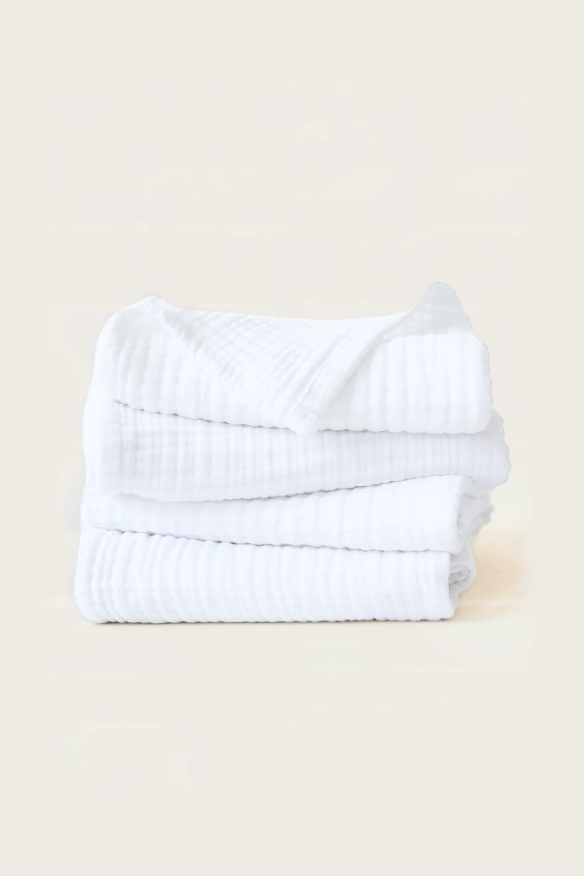 Stacked white muslin Turkish cotton towels showing the soft 4-layer gauze weave, handwoven in Denizli